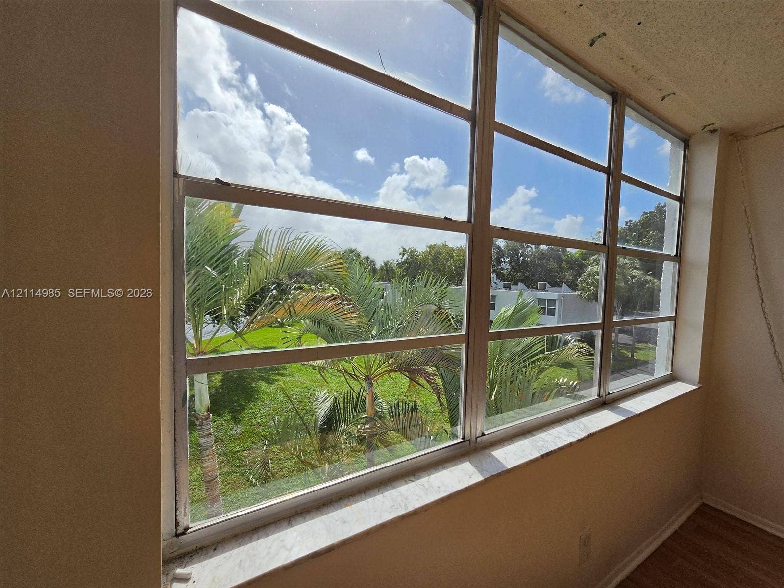 9441 Live Oak Place, #308, Davie, Davie, FL 33324 Expansive multi-pane window featuring a deep stone-finish sill and wood-finish flooring