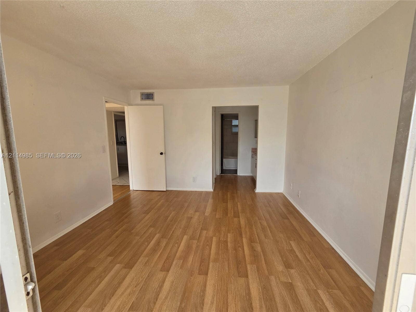 9441 Live Oak Place, #308, Davie, Davie, FL 33324 Interior room featuring wood-finish flooring, neutral wall paint, and multiple interior doorways