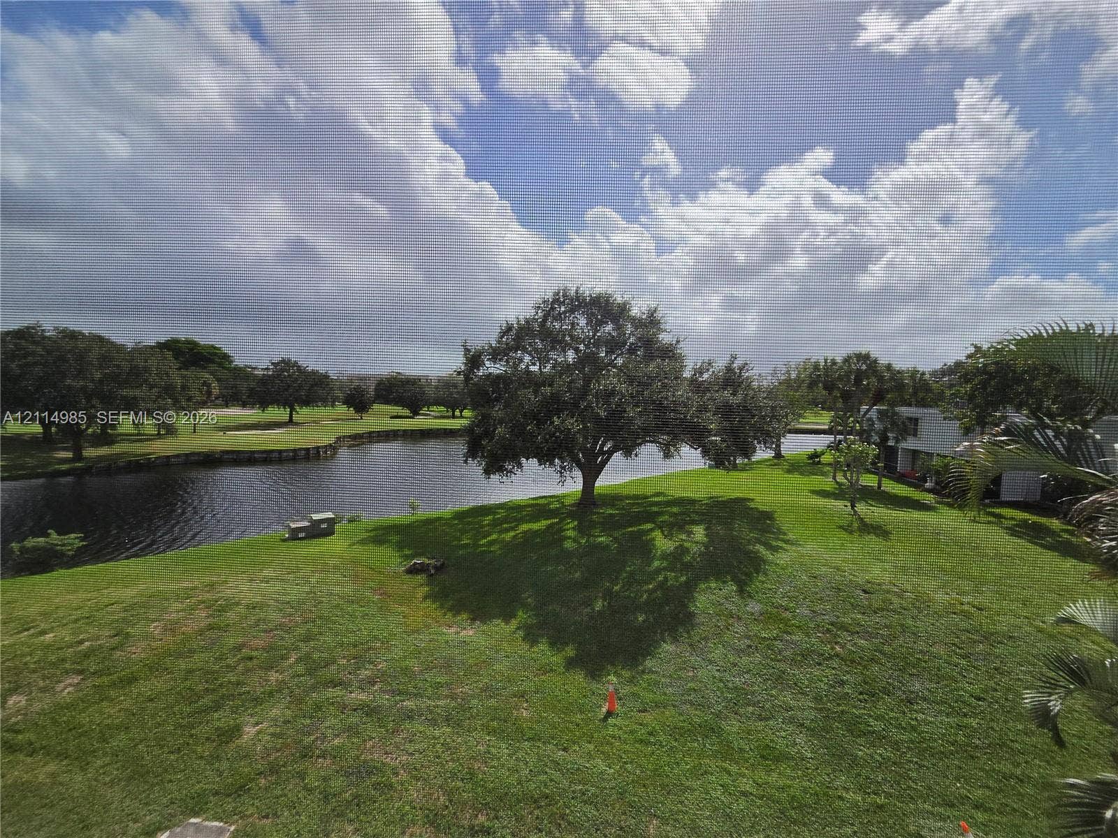 9441 Live Oak Place, #308, Davie, Davie, FL 33324 Expansive grounds featuring a water frontage, mature trees, and open green space