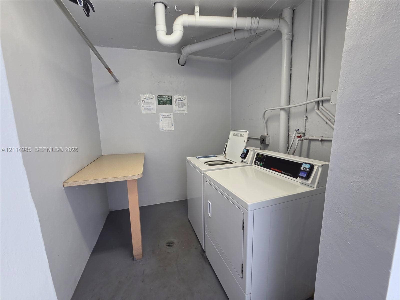 9441 Live Oak Place, #308, Davie, Davie, FL 33324 Laundry area featuring a top-load washer, a front-load dryer, and a built-in folding counter