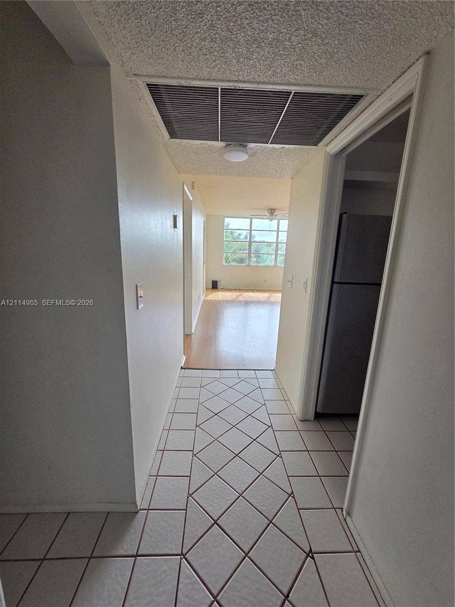 9441 Live Oak Place, #308, Davie, Davie, FL 33324 Ceramic tile flooring arranged in a diagonal pattern, wood-finish flooring, and multi-pane window