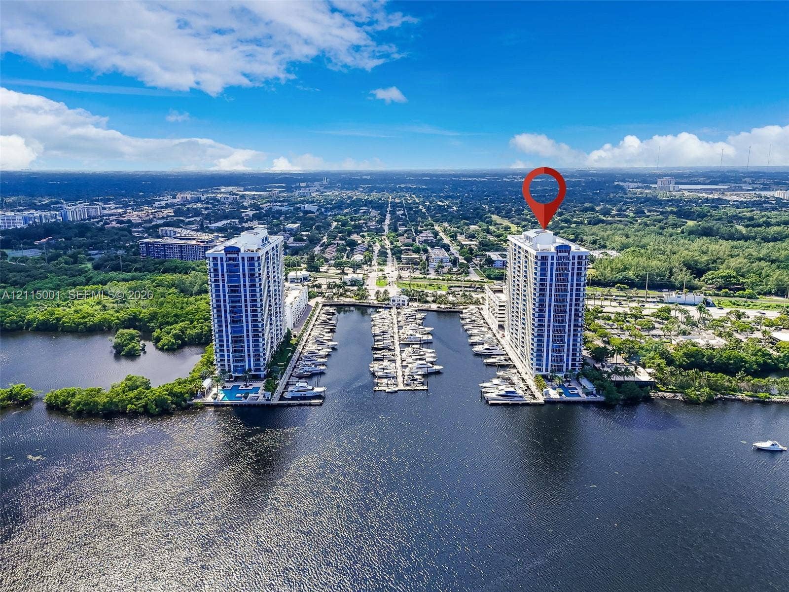 High-rise residential tower featuring direct water frontage, a private deep-water marina, and ground-level outdoor swimming pools