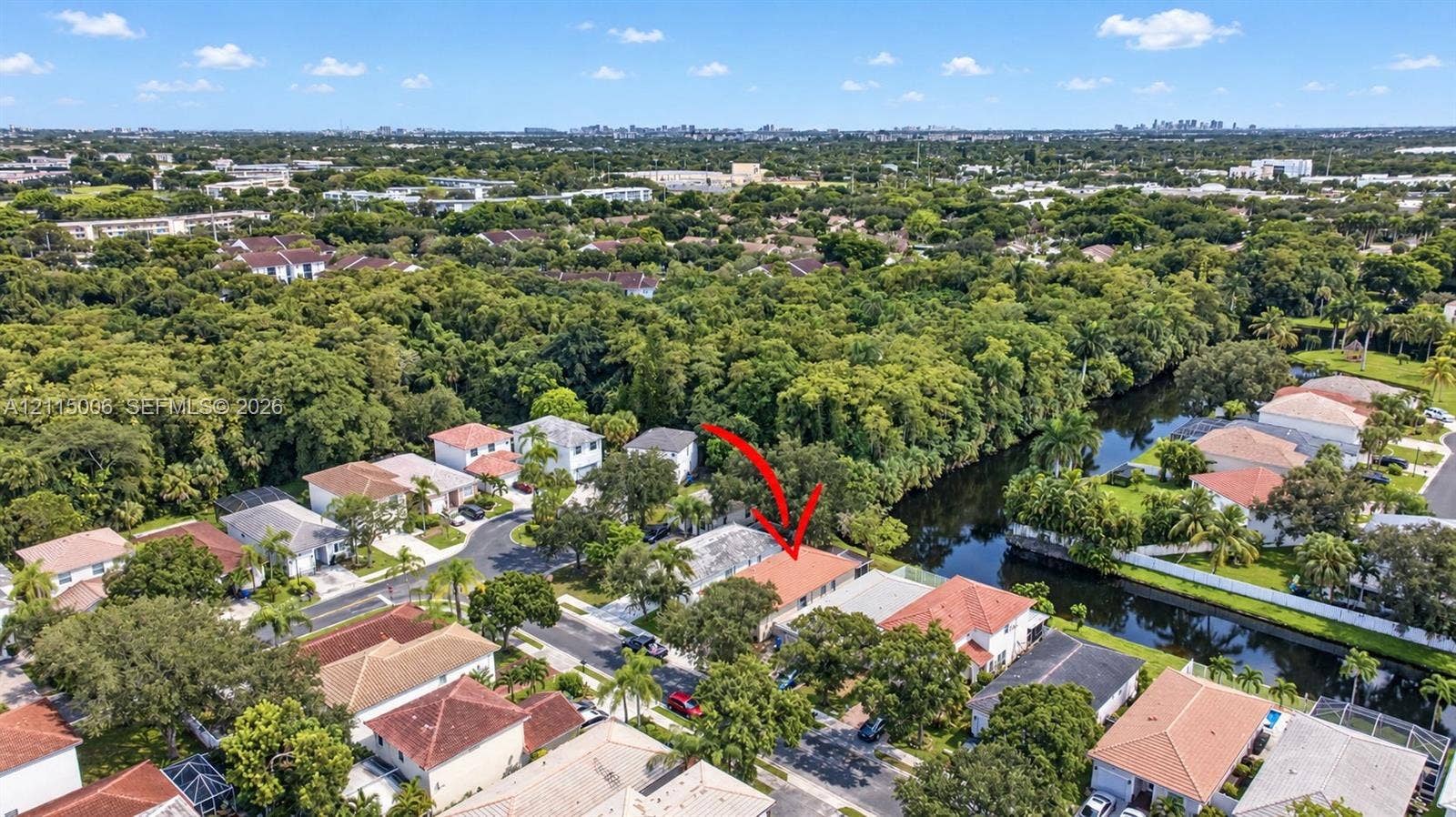 4812 NW 19th Street, Coconut Creek, FL 33063 Aerial perspective of a single-story residence featuring a terracotta-tiled roof and a rear canal-front location