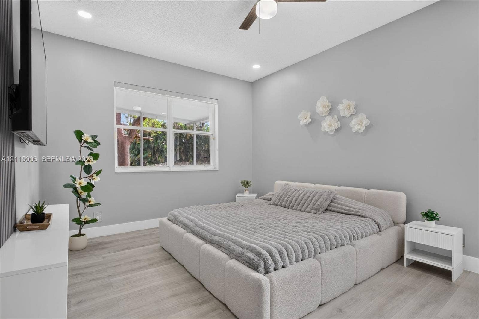 4812 NW 19th Street, Coconut Creek, FL 33063 Bedroom featuring light-toned wood-finish flooring, recessed lighting, and a ceiling fan with integrated lighting