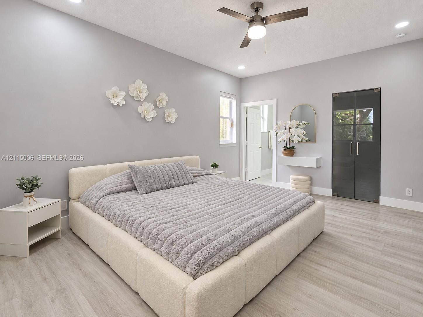4812 NW 19th Street, Coconut Creek, FL 33063 Neutral interior featuring wood-finish flooring, recessed lighting, a modern ceiling fan, and dark-tinted glass panel doors