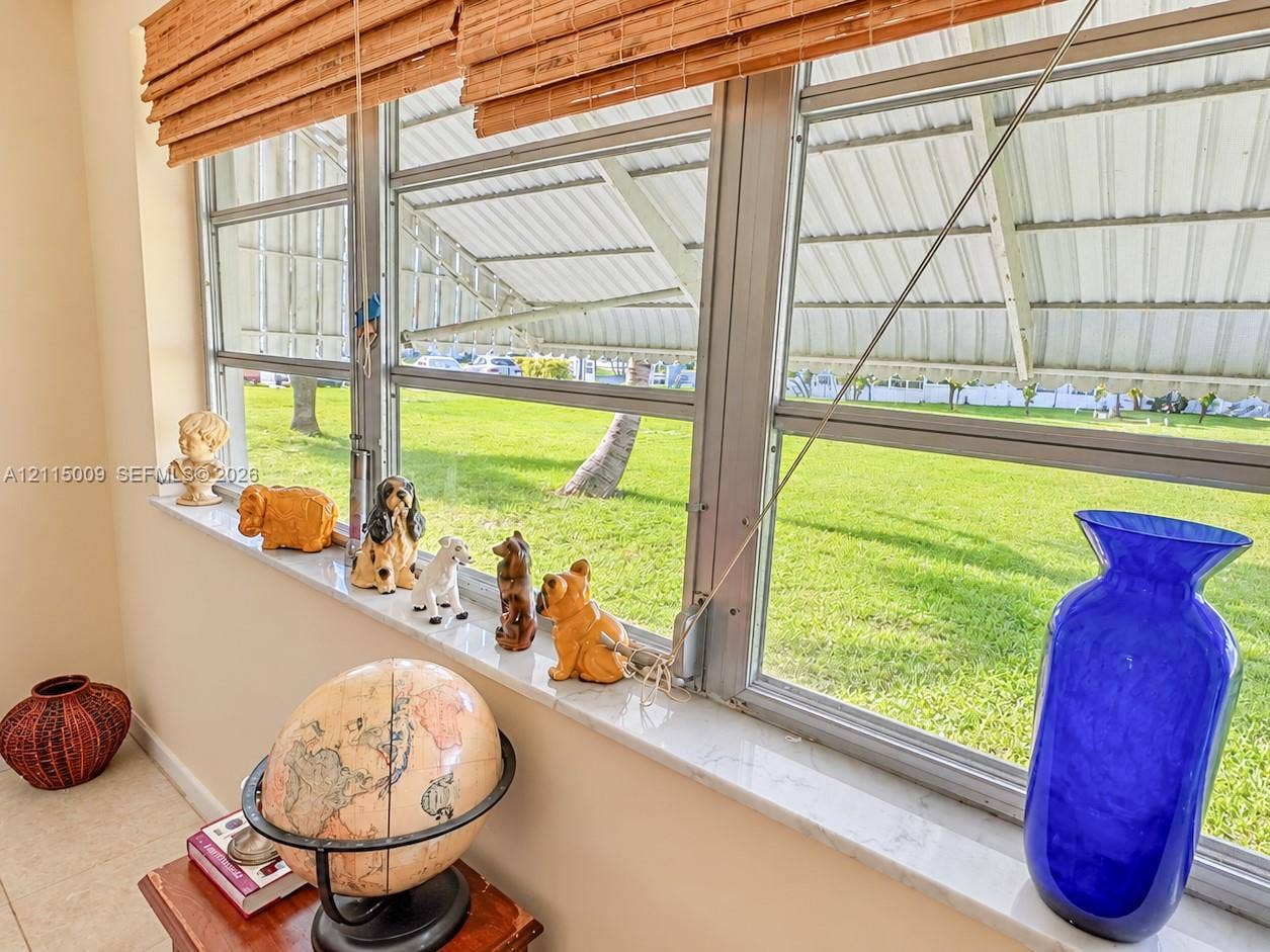 2300 Park Lane, #105, Hollywood, FL 33021 Horizontal sliding windows with metal framing, stone-finish windowsill, and overhead awning