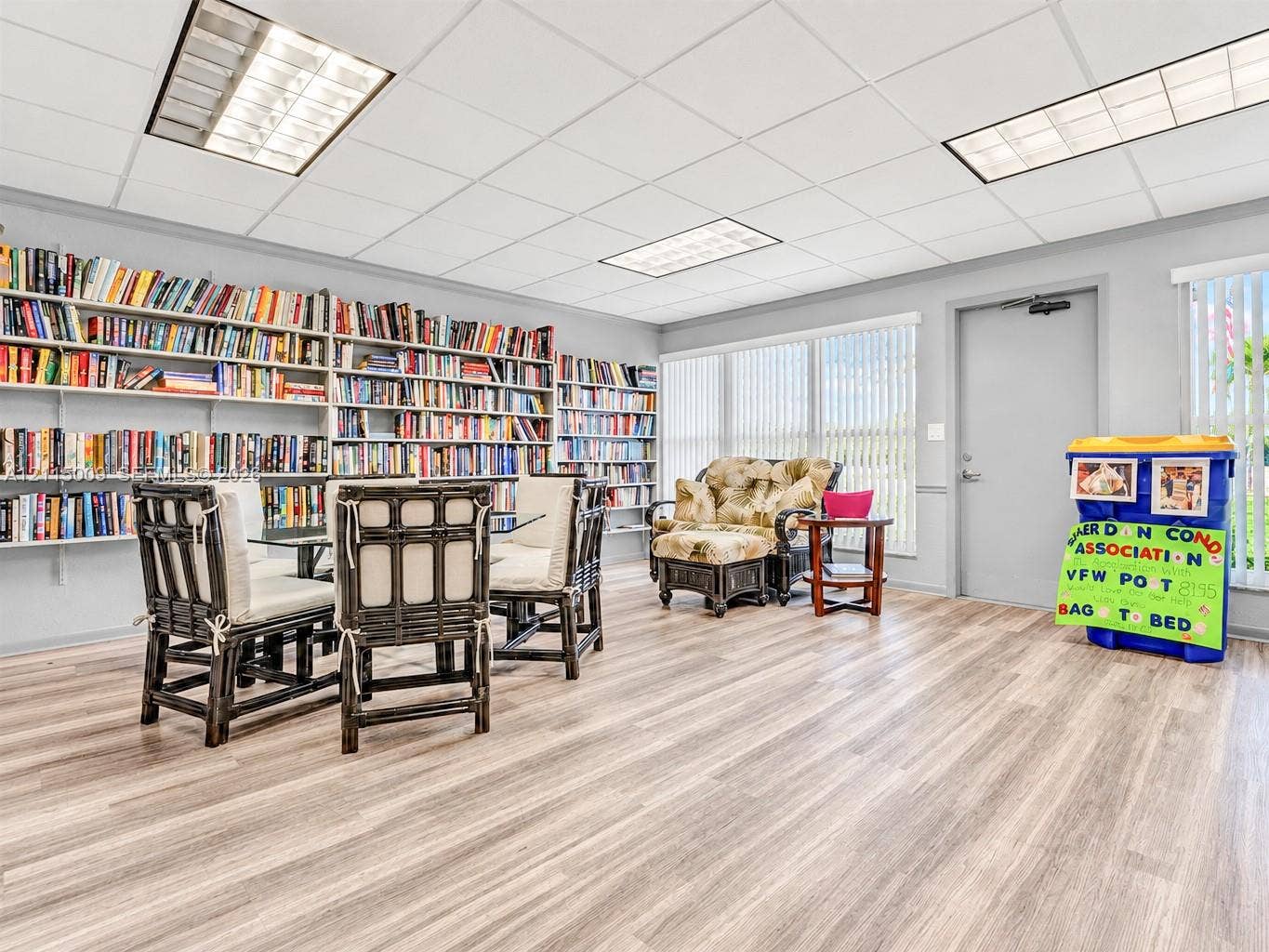 2300 Park Lane, #105, Hollywood, FL 33021 Spacious room featuring floor-to-ceiling built-in shelving, wood-finish flooring, recessed lighting, and expansive windows with vertical blinds