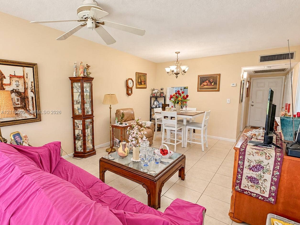 2300 Park Lane, #105, Hollywood, FL 33021 Living area featuring ceramic tile flooring, a multi-blade ceiling fan, and a multi-arm chandelier