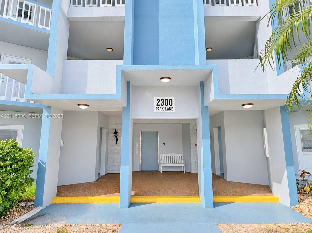 2300 Park Lane, #105, Hollywood, FL 33021 Multi-level exterior featuring concrete structural pillars, covered entryways, inset balconies, and integrated recessed lighting