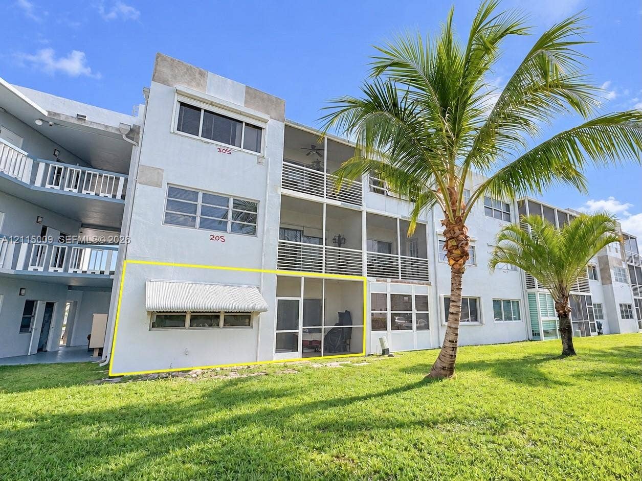 2300 Park Lane, #105, Hollywood, FL 33021 Ground-level unit featuring a screened-in lanai, retractable metal window awning, and exterior access