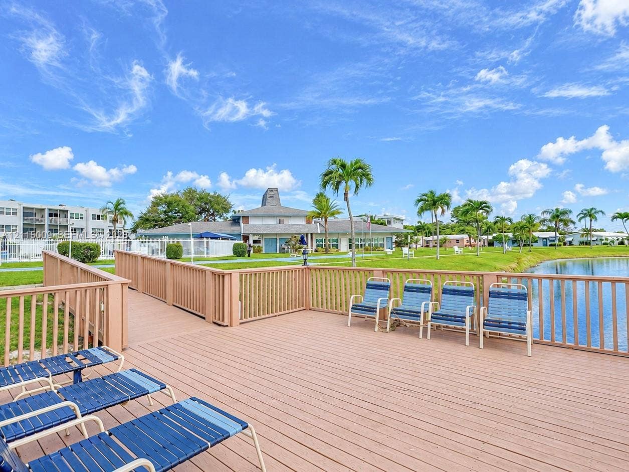 2300 Park Lane, #105, Hollywood, FL 33021 Waterfront wooden deck featuring perimeter fencing and open-air space