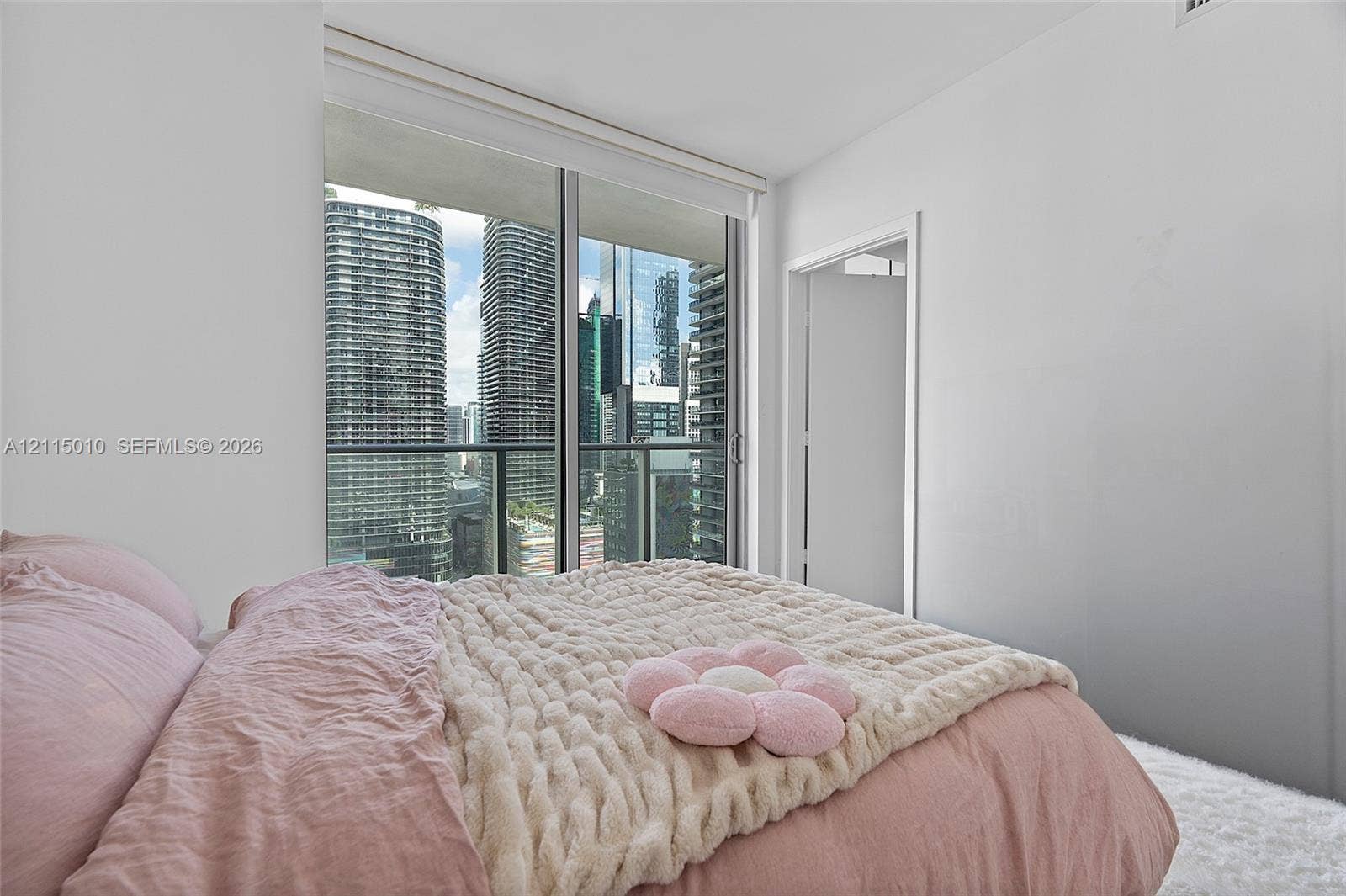 1100 S Miami Avenue, #2407, Miami, FL 33130 Floor-to-ceiling glass sliding doors, private balcony, and urban high-rise scenery