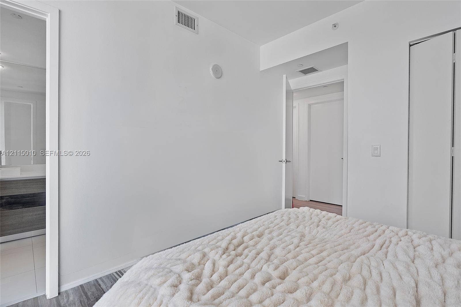 1100 S Miami Avenue, #2407, Miami, FL 33130 Neutral interior featuring wood-finish flooring, white walls, and a multi-panel closet door