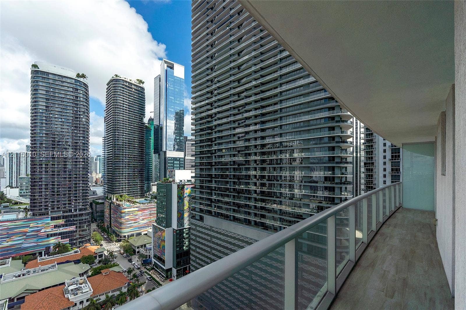 1100 S Miami Avenue, #2407, Miami, FL 33130 Covered balcony featuring wood-finish flooring and a glass panel railing