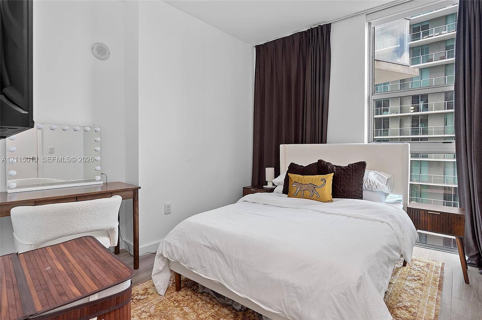 1100 S Miami Avenue, #2407, Miami, FL 33130 Floor-to-ceiling window featuring natural light, wood-finish flooring, and neutral wall tones