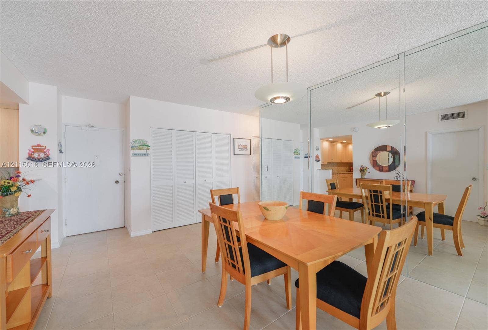 1950 S Ocean Drive, #20N, Hallandale Beach, FL 33009 Tile flooring, floor-to-ceiling mirror paneling, and a modern pendant light fixture