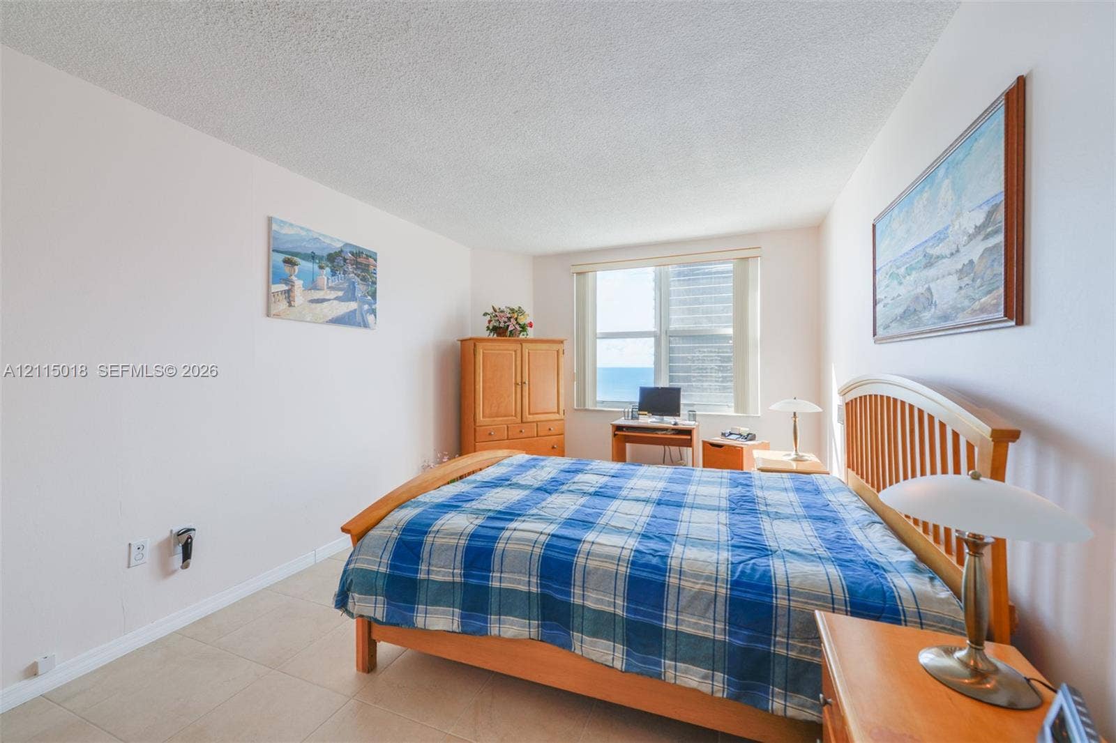 1950 S Ocean Drive, #20N, Hallandale Beach, FL 33009 Neutral-toned interior space featuring tile flooring, a large window, and light-reflecting wall surfaces