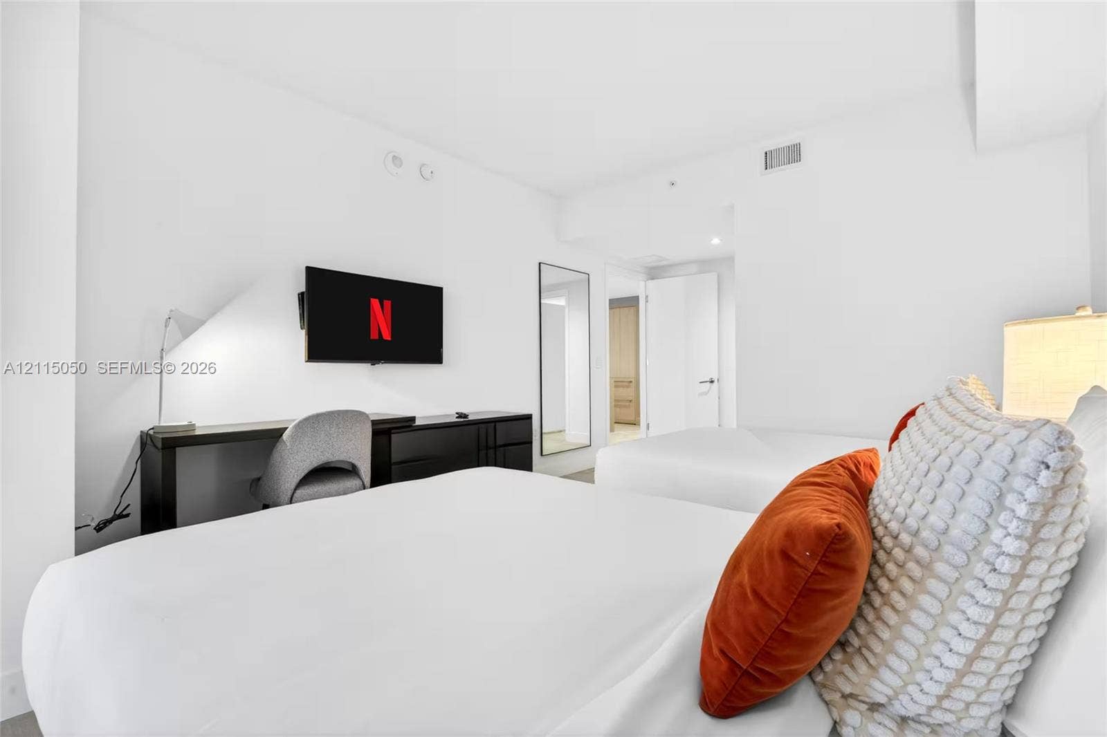 Neutral interior featuring smooth white wall finishes and recessed lighting