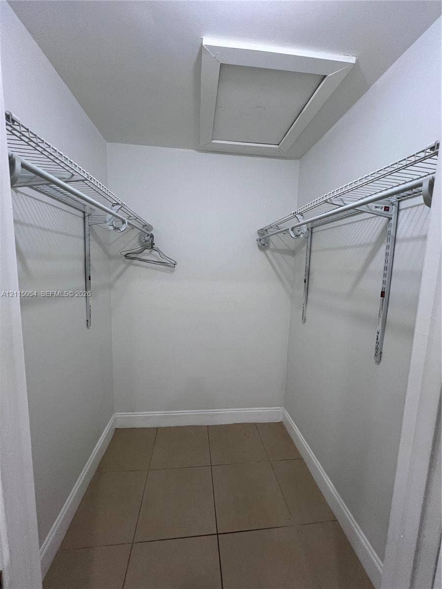 17500 NW 67th Court, #H-19, Hialeah, Hialeah, FL 33015 Storage area featuring ceramic tile flooring, dual-level wire shelving, and attic access panel