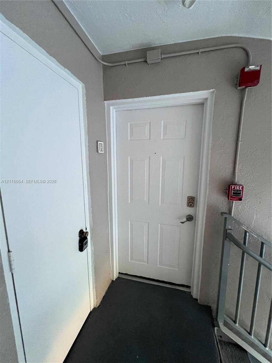 17500 NW 67th Court, #H-19, Hialeah, Hialeah, FL 33015 Six-panel entry door featuring a brushed metal keypad lock and peephole