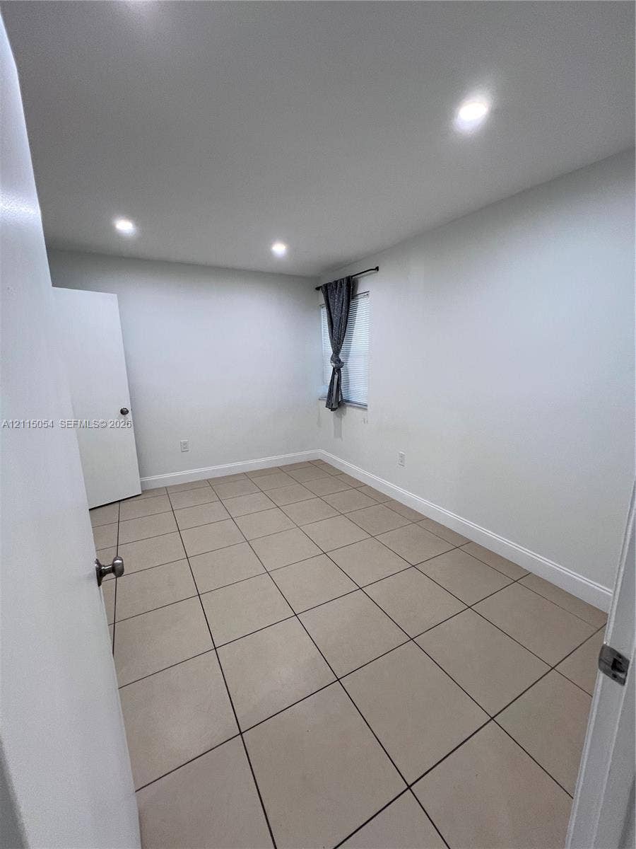 17500 NW 67th Court, #H-19, Hialeah, Hialeah, FL 33015 Interior space featuring ceramic tile flooring, recessed ceiling lighting, and a single window