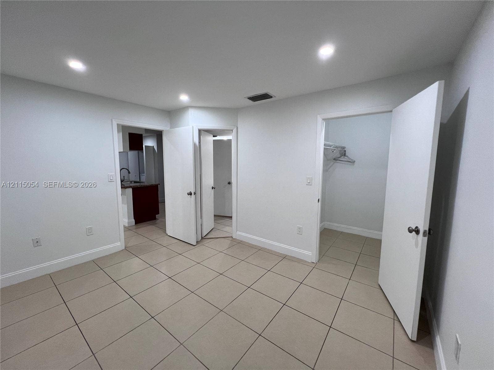 17500 NW 67th Court, #H-19, Hialeah, Hialeah, FL 33015 Neutral-toned tile flooring, recessed ceiling lighting, and multiple interior doorways with built-in closet shelving