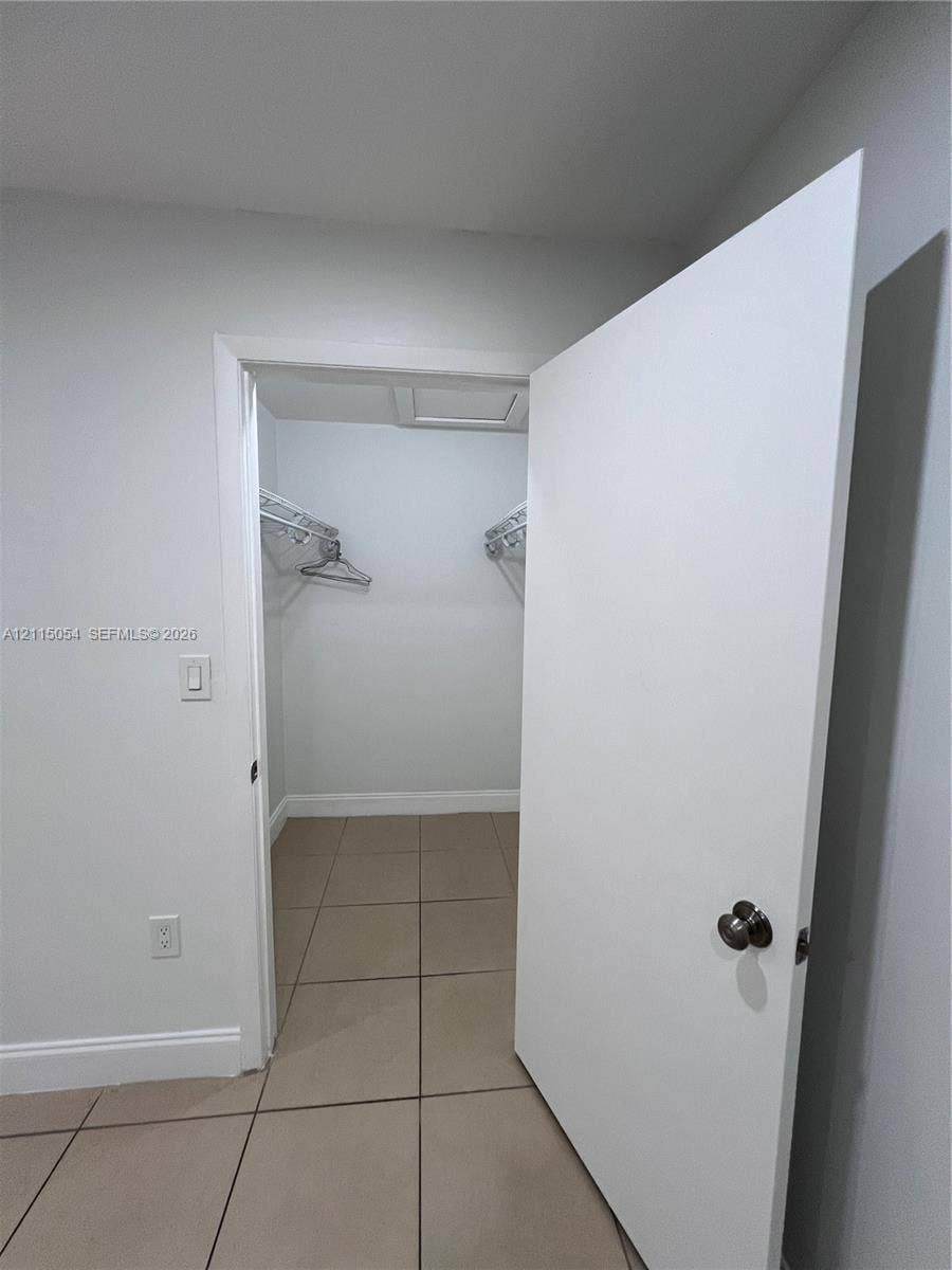 17500 NW 67th Court, #H-19, Hialeah, Hialeah, FL 33015 Walk-in closet featuring large-format neutral tile flooring and built-in wire shelving