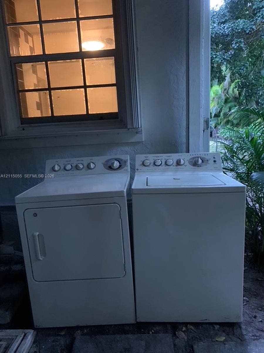 11728 NE 6th Avenue, #2, Biscayne Park, Biscayne Park, FL 33161 Multi-pane window with white trim, top-load clothes washer, and front-load clothes dryer