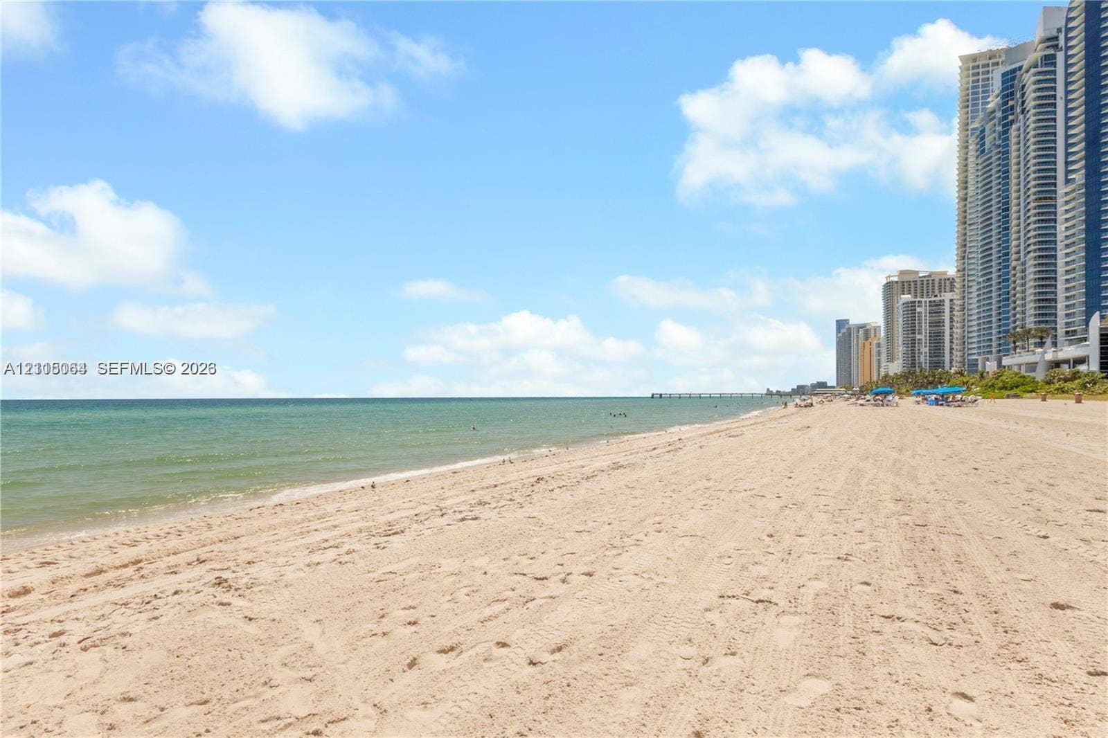 17315 Collins Avenue, #1808, Sunny Isles Beach, FL 33160 Sandy beachfront shoreline featuring direct ocean access and coastal proximity to high-rise structures