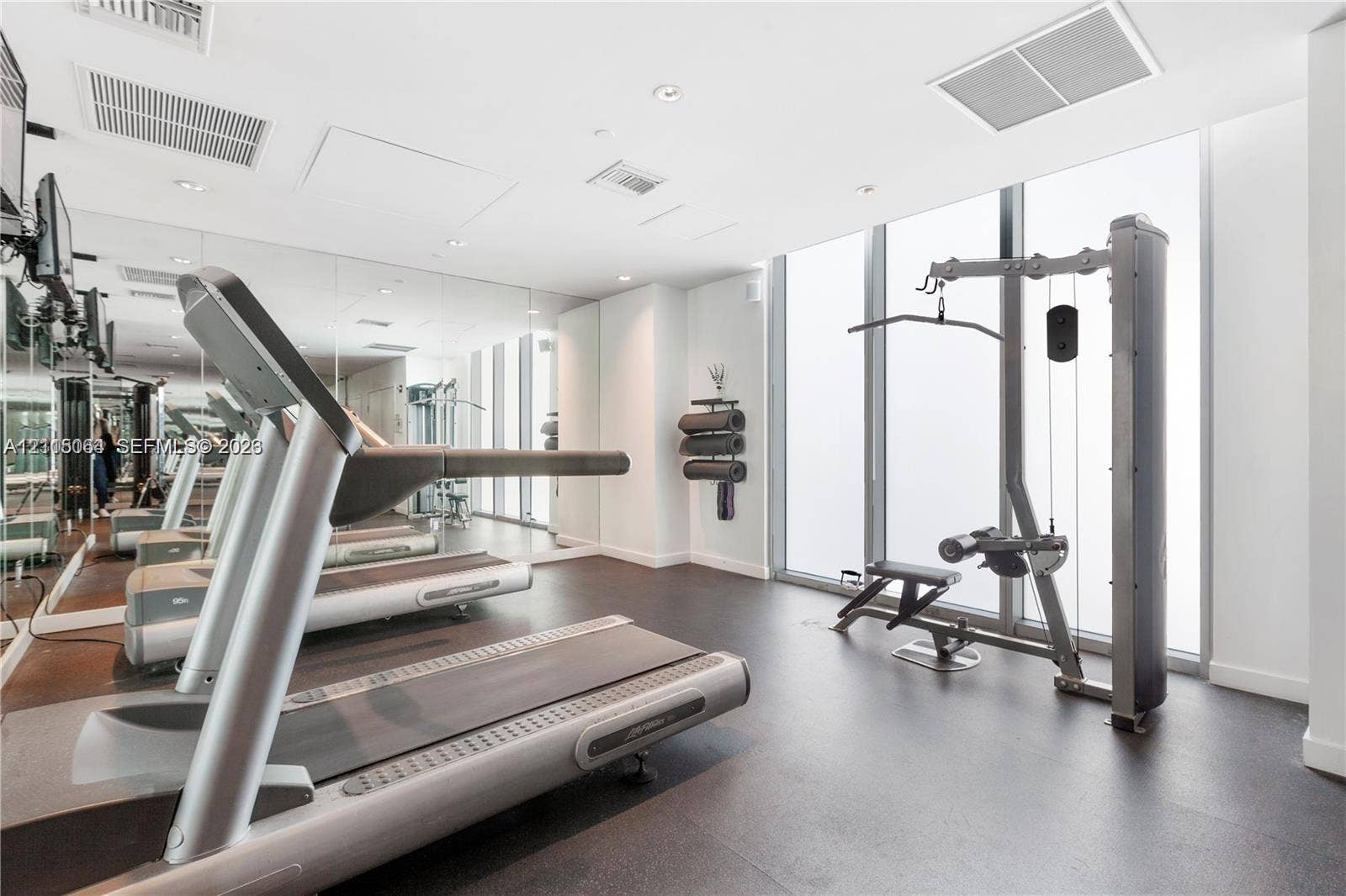 17315 Collins Avenue, #1808, Sunny Isles Beach, FL 33160 Fitness center featuring floor-to-ceiling windows, full-wall mirrors, recessed lighting, and resilient flooring