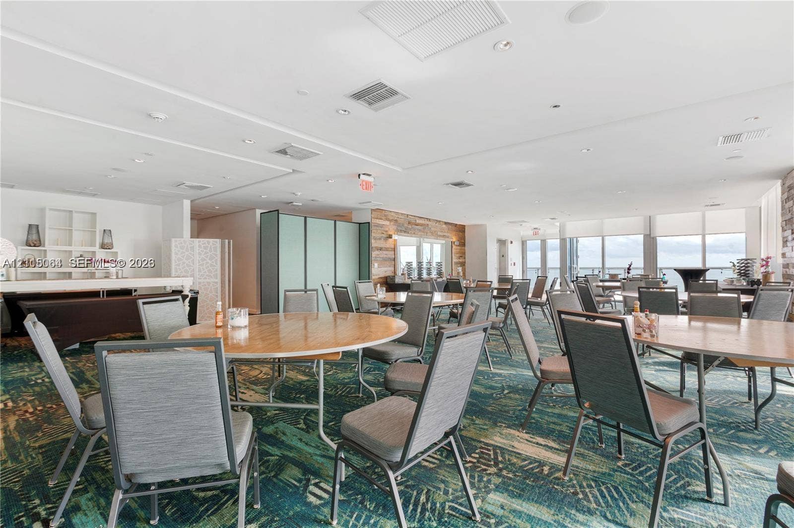 17315 Collins Avenue, #1808, Sunny Isles Beach, FL 33160 Open-concept room featuring a textured wood-plank accent wall, recessed lighting, and expansive floor-to-ceiling windows