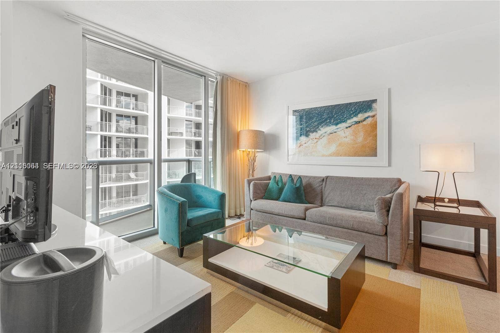 17315 Collins Avenue, #1808, Sunny Isles Beach, FL 33160 Floor-to-ceiling windows providing extensive natural light, private balcony access, and neutral wall finishes