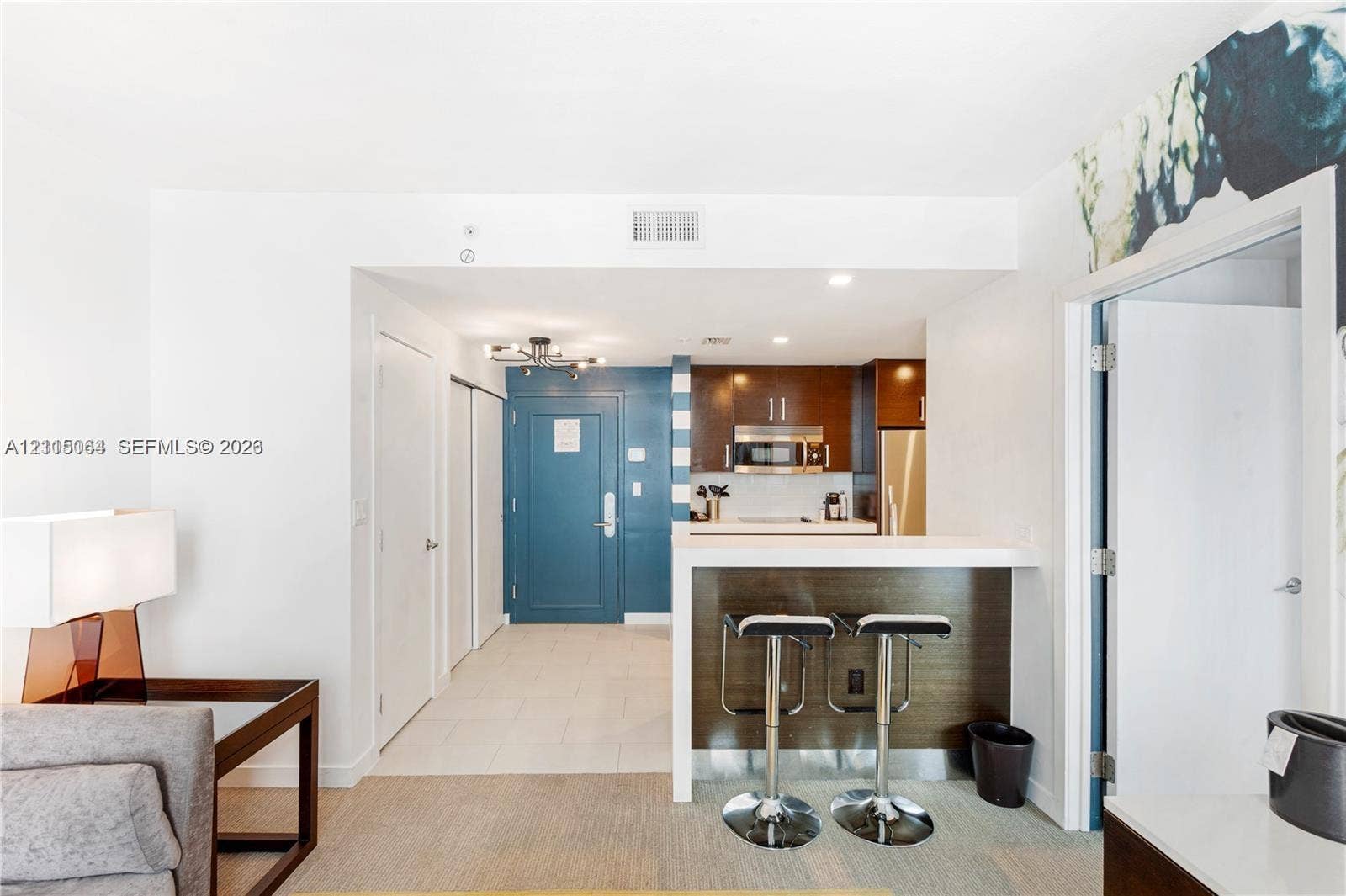 17315 Collins Avenue, #1808, Sunny Isles Beach, FL 33160 Kitchen featuring a breakfast bar, flat-panel cabinetry, stainless steel appliances, and a built-in microwave