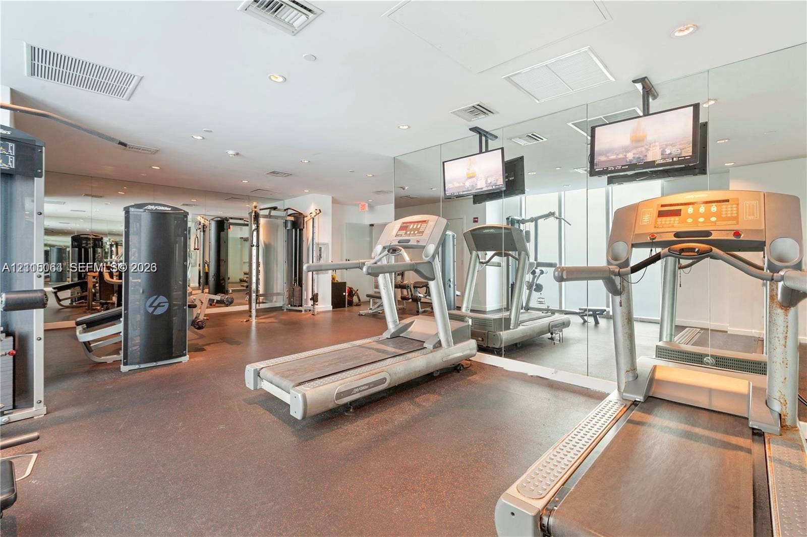 17315 Collins Avenue, #1808, Sunny Isles Beach, FL 33160 Fitness center featuring mirrored walls, recessed lighting, and rubberized flooring