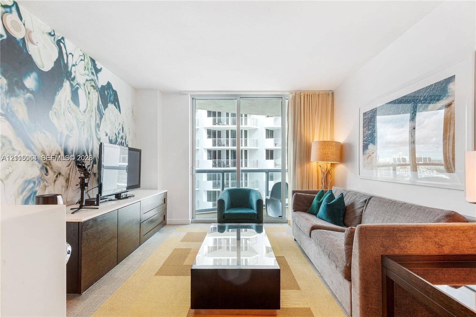 17315 Collins Avenue, #1808, Sunny Isles Beach, FL 33160 Full-height glass sliding doors, custom wall mural, built-in cabinetry, and neutral wall-to-wall carpeting