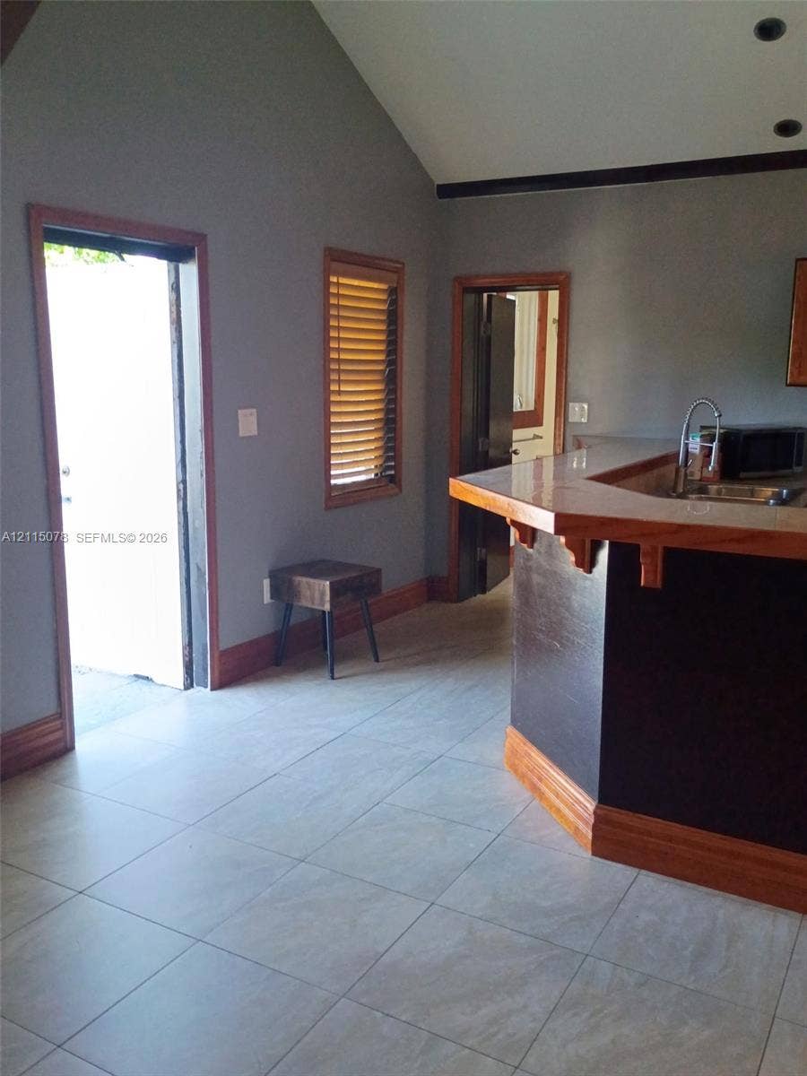 209 SW 12th Street, #A, Dania, Dania Beach, FL 33004 Vaulted ceiling, ceramic tile flooring, and bar-height counter with wood trim