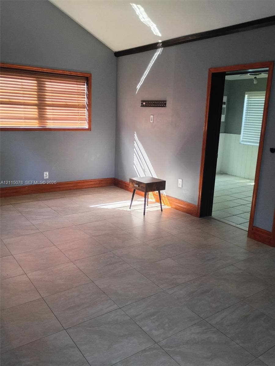 209 SW 12th Street, #A, Dania, Dania Beach, FL 33004 Vaulted ceiling, large-format tile flooring, and natural wood-finish window and doorway casing