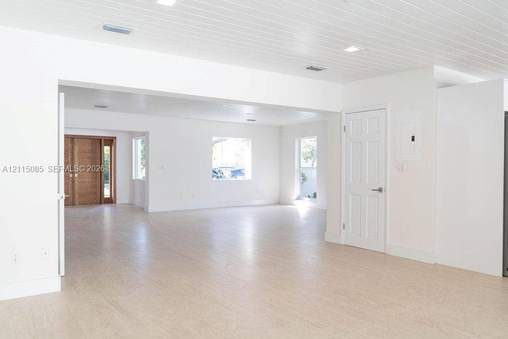 663 Woodcrest Road, Key Biscayne, Key Biscayne, FL 33149 Open-concept interior featuring light-toned porcelain tile flooring, tongue-and-groove wood-finish ceiling, recessed lighting, and a six-panel interior door