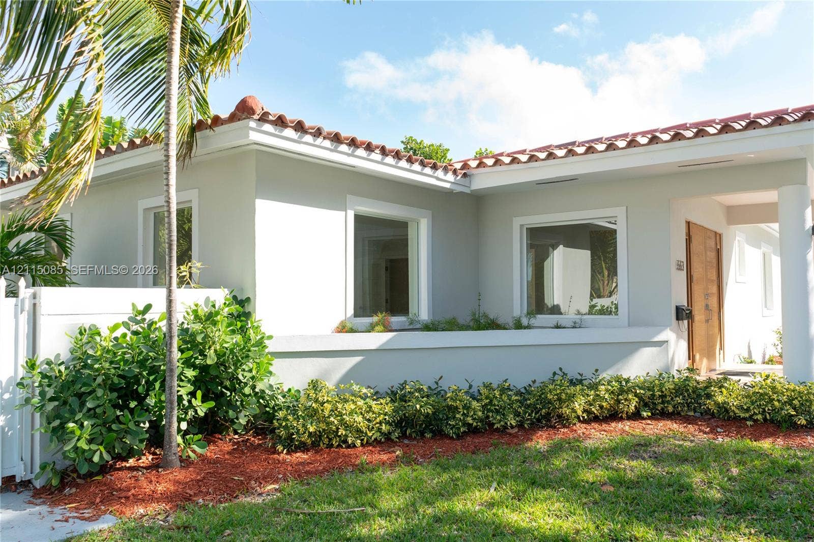 663 Woodcrest Road, Key Biscayne, Key Biscayne, FL 33149 Stucco exterior featuring a clay tile roof, covered entryway, and wood-finish front door