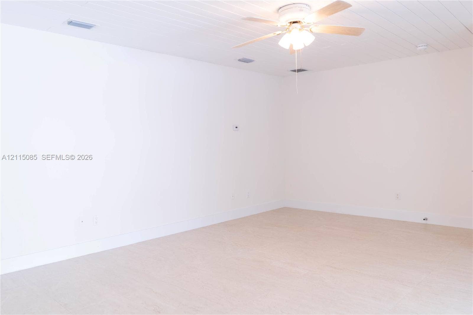 663 Woodcrest Road, Key Biscayne, Key Biscayne, FL 33149 Plank-style ceiling, light-toned porcelain tile flooring, and integrated ceiling fan with multi-light fixture