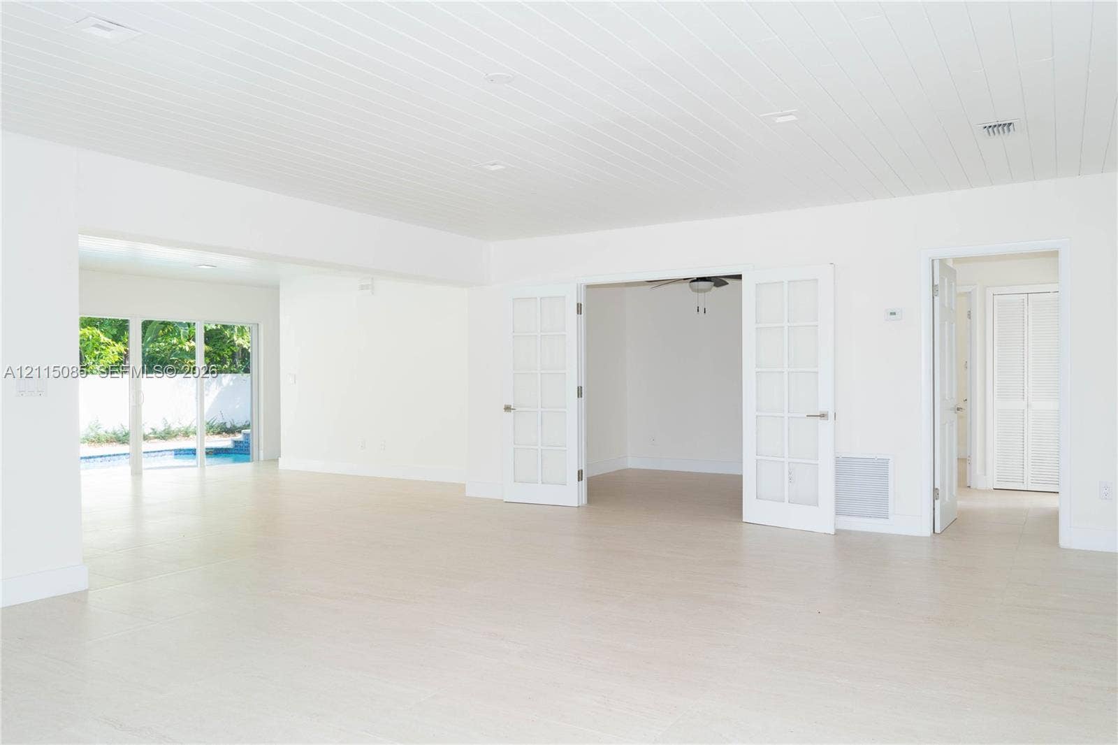 663 Woodcrest Road, Key Biscayne, Key Biscayne, FL 33149 light-toned porcelain tile flooring, tongue-and-groove paneled ceiling, French doors with glass panes, and recessed lighting