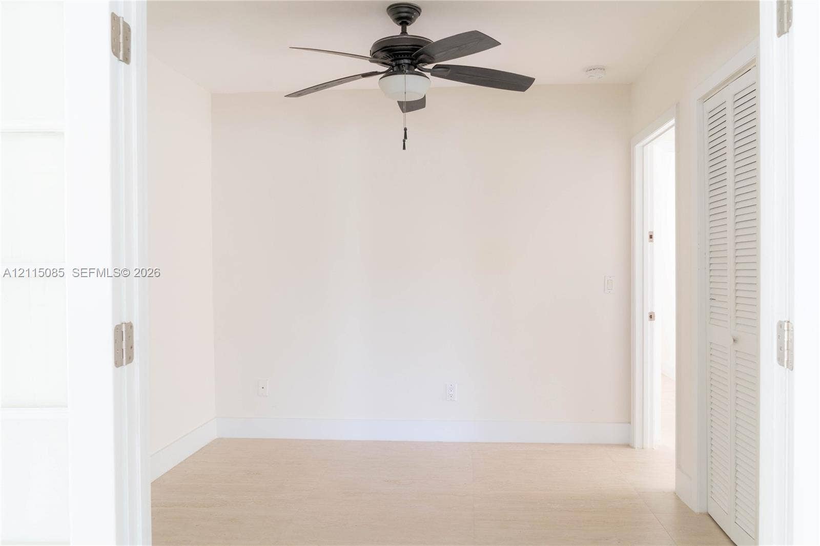 663 Woodcrest Road, Key Biscayne, Key Biscayne, FL 33149 Room featuring French doors, light-toned porcelain tile flooring, a ceiling fan with integrated lighting, and a louvered bi-fold closet door