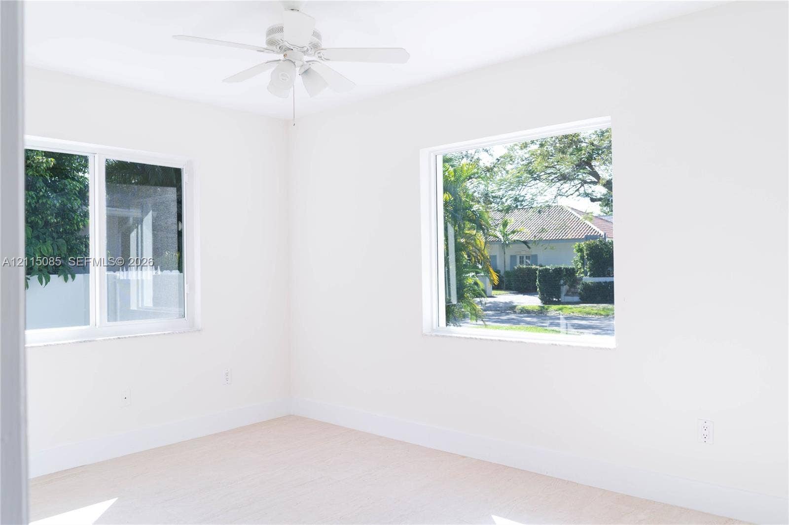 663 Woodcrest Road, Key Biscayne, Key Biscayne, FL 33149 Bright interior room featuring dual windows, neutral wall finishes, and an overhead ceiling fan