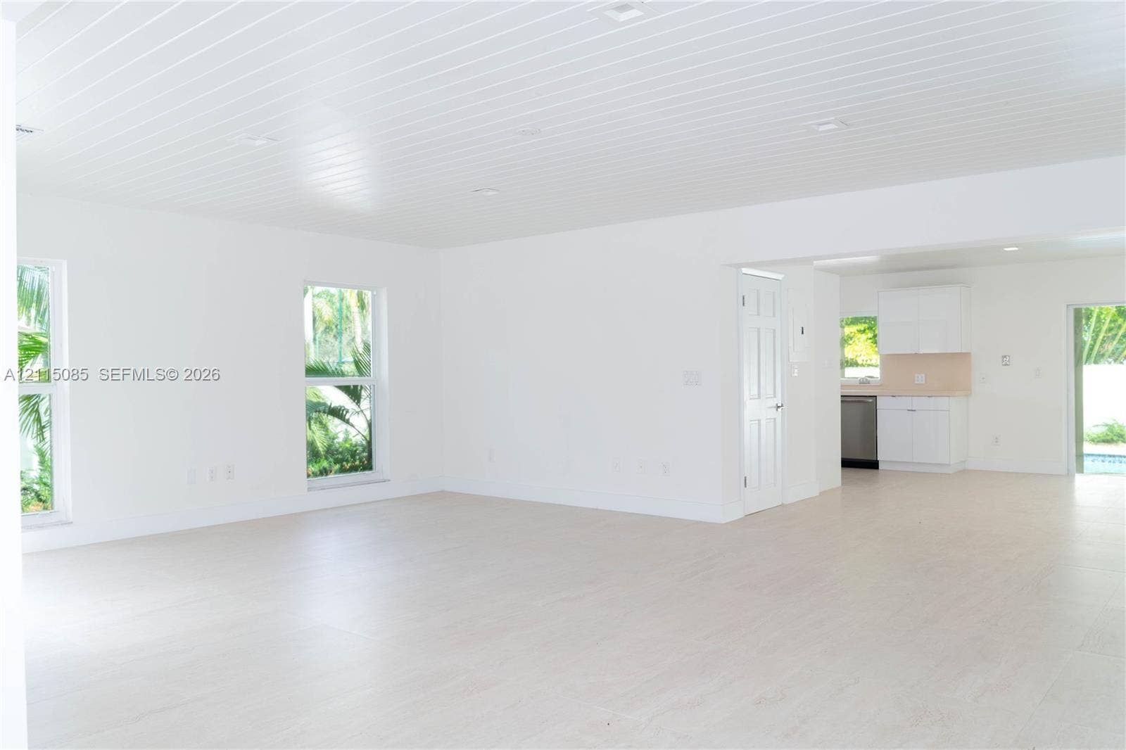 663 Woodcrest Road, Key Biscayne, Key Biscayne, FL 33149 Open-concept interior featuring light-toned porcelain tile flooring, recessed lighting, and a plank-style ceiling
