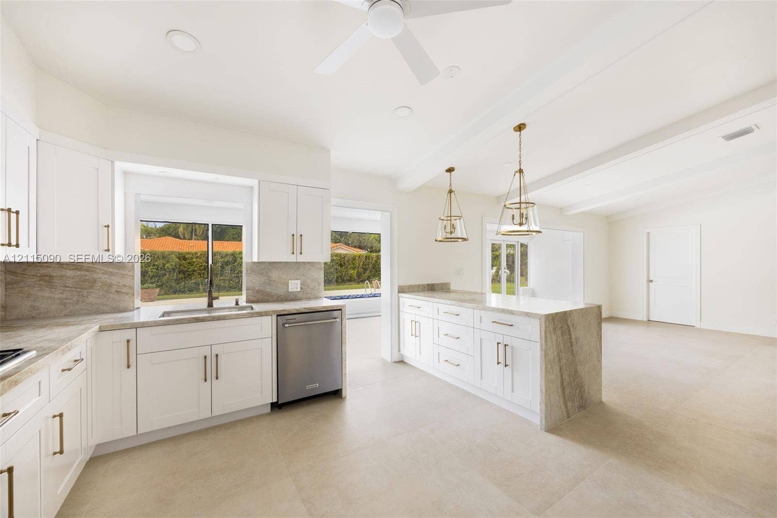 12900 SW 71st Avenue, Pinecrest, Pinecrest, FL 33156 Kitchen featuring white shaker-style cabinetry, waterfall-edge stone countertops, stainless steel dishwasher, pendant lighting, and oversized tile flooring