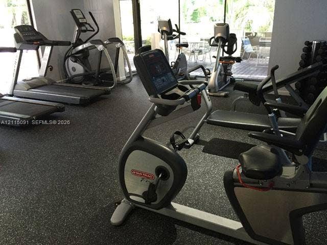 7715 SW 86th Street, #A2-402, Miami, Miami, FL 33143 Fitness facility featuring rubberized flooring and expansive floor-to-ceiling windows