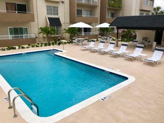 7715 SW 86th Street, #A2-402, Miami, Miami, FL 33143 Swimming pool with tiled perimeter, concrete deck, and covered pavilion