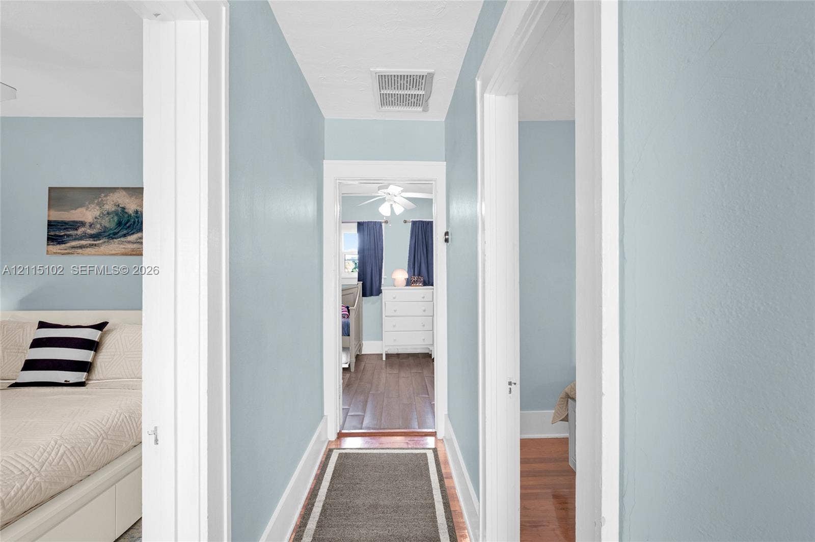110 S Peninsula, New Smyrna Beach, FL 32169 Hallway featuring wood-finish flooring and white door casing