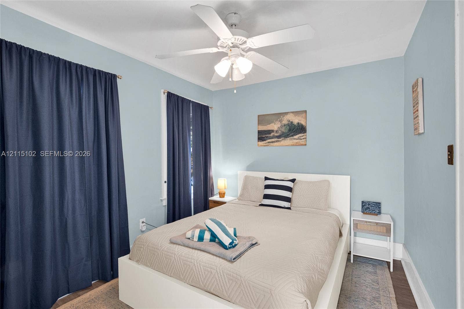 110 S Peninsula, New Smyrna Beach, FL 32169 Bedroom featuring wood-finish flooring and a central ceiling fan with integrated lighting