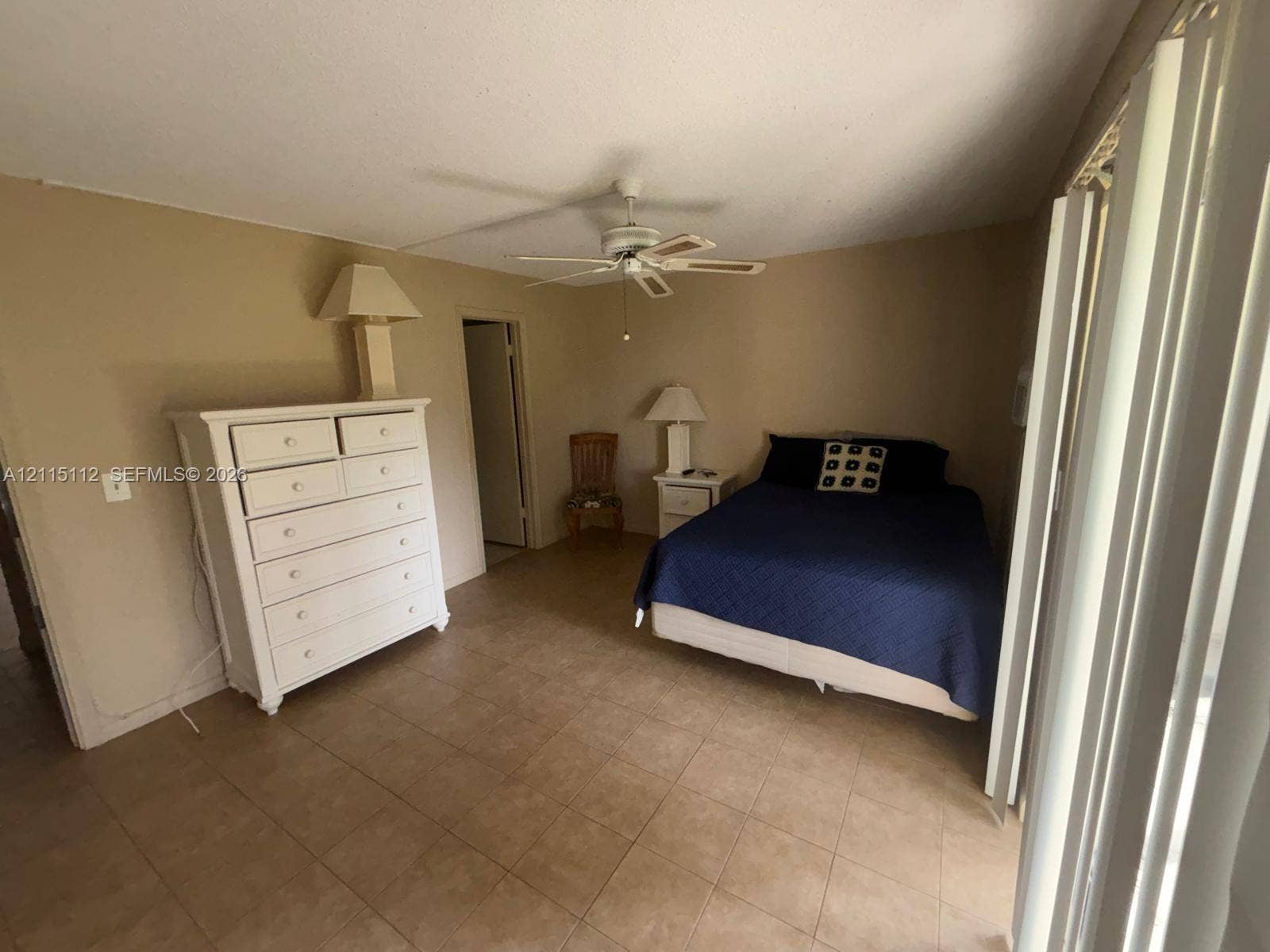 89 Andover D, #89, West Palm Beach, West Palm Beach, FL 33417 Spacious room featuring neutral wall paint, tile flooring, and a ceiling-mounted fan with integrated lighting